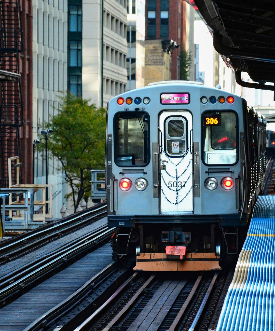 Chicago CTA Pink Line Train arriving at a station